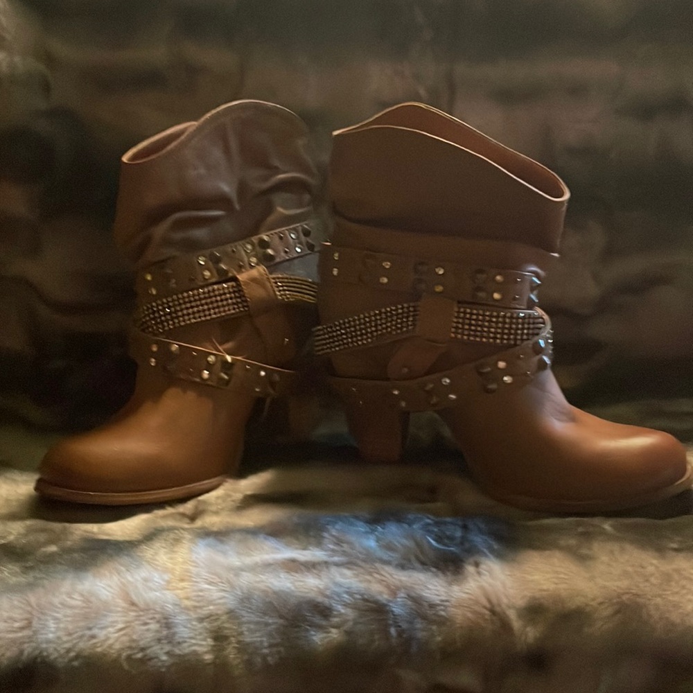 Sharp ankle booties with embellished strap detail. Faux leather